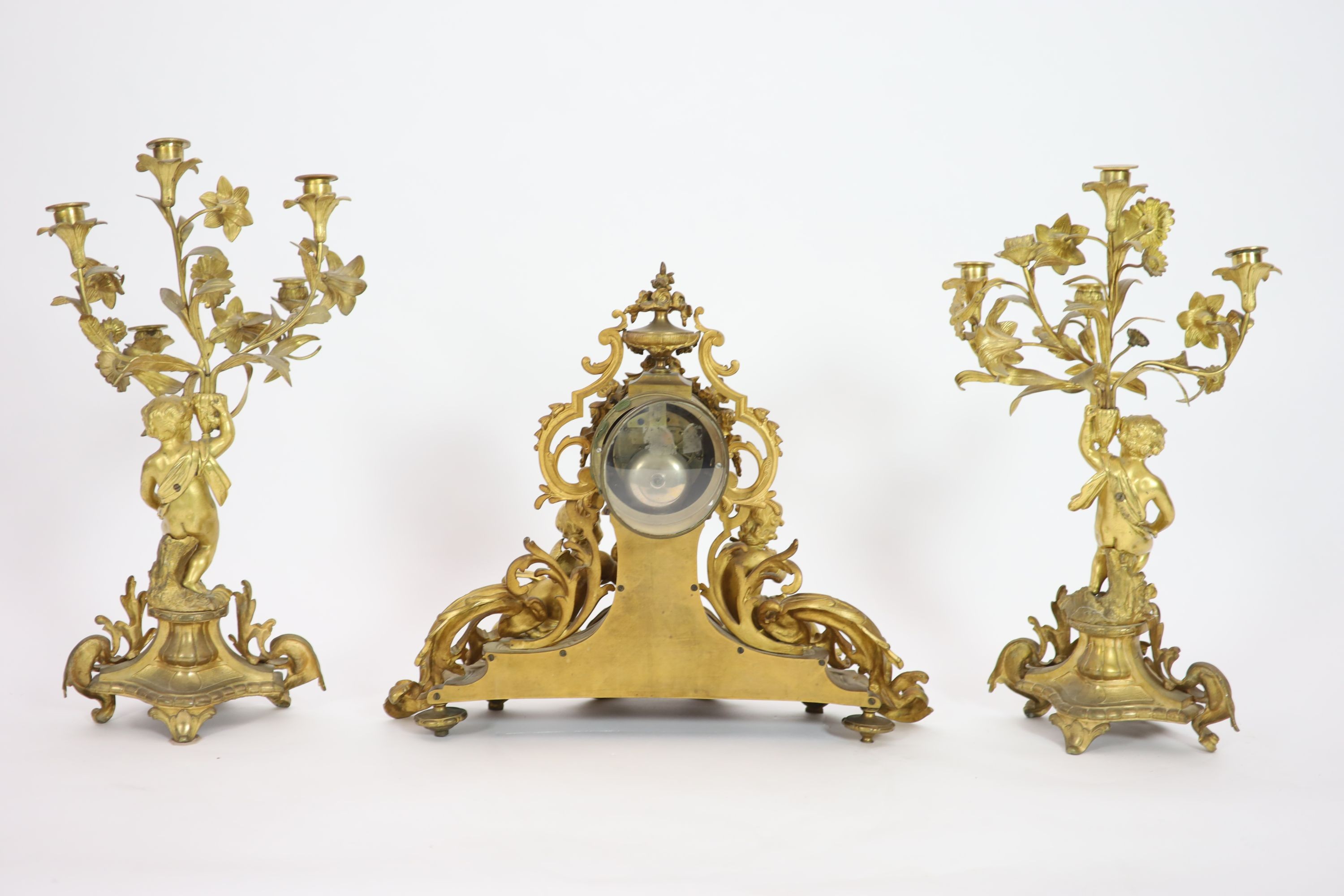 A 19th century Louis XV style ormolu clock garniture, clock H 43cm candelabra H 52cm